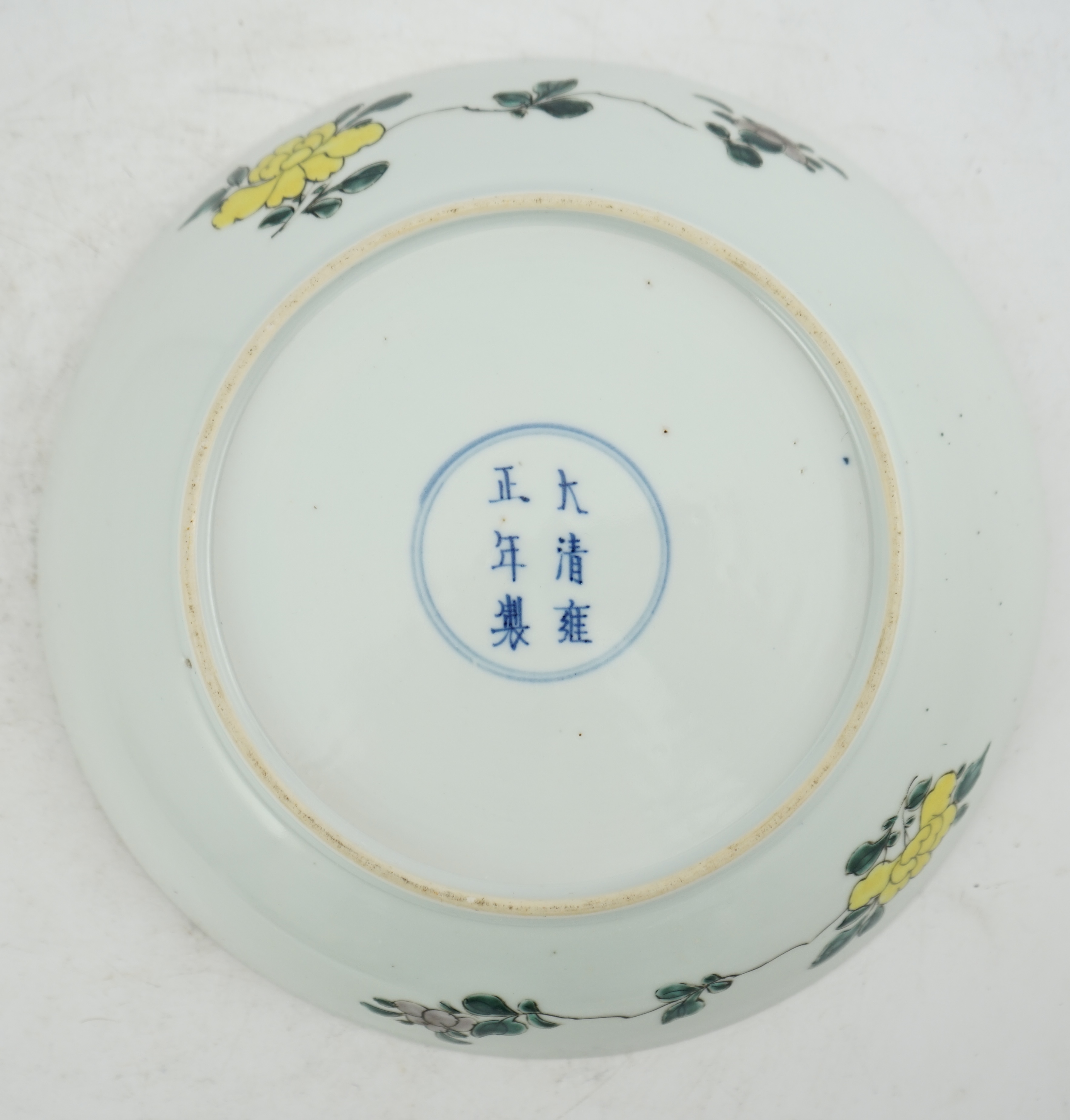 A Chinese famille rose ‘peony and prunus’ saucer dish, Yongzheng mark and period (1723-35)